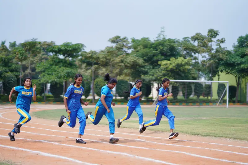 Students running on the athletics track