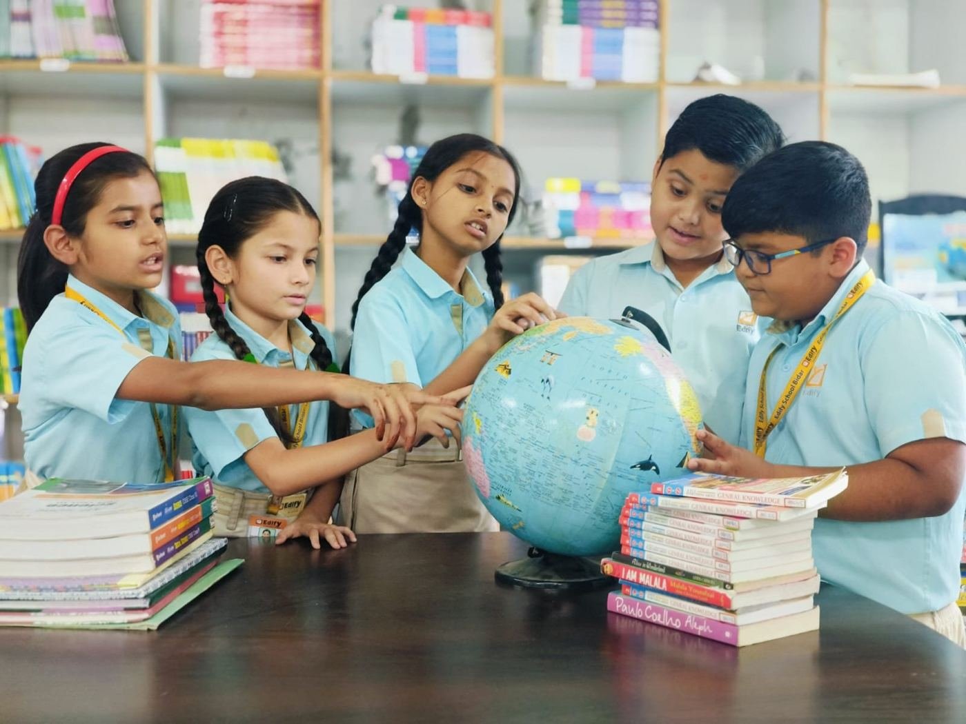 Students exploring the globe